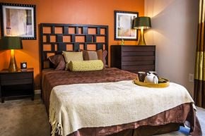 Reston apartment for rent - A bedroom with a bed, nightstands, and lamps.