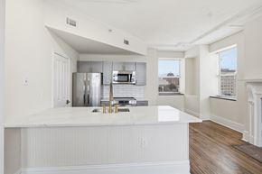 Richmond apartment for rent - A kitchen with white cabinets and a white counter top.