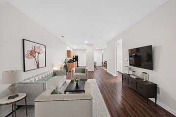 Martinsburg townhouse for rent - A living room with a white couch and a painting of flowers on the wall.