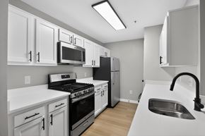Fredericksburg apartment for rent - A kitchen with white cabinets and appliances.