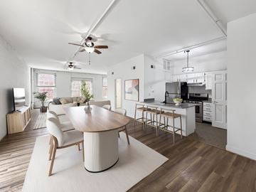 Richmond apartment for rent - A modern living room with a wooden table and chairs.
