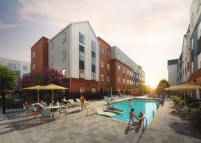 Richmond apartment for rent - A pool area with people relaxing and swimming in front of a multi-story building.