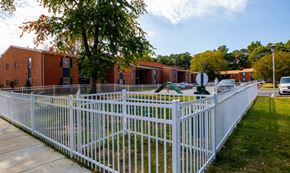 Newport News apartment for rent - a white fence in front of a playground