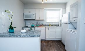 Newport News apartment for rent - a kitchen with white appliances and granite counter tops