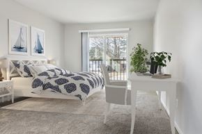 Virginia Beach apartment for rent - a bedroom with a bed and a white desk and a window