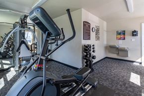 Newport News apartment for rent - a gym with cardio equipment and weights in a building