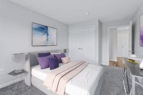 Laurel apartment for rent - a bedroom with a white bed and purple pillows