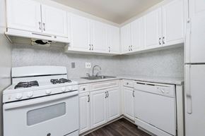 Herndon apartment for rent - a white kitchen with white cabinets and white appliances