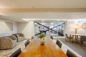 Alexandria apartment for rent - A conference room with a long wooden table and chairs.