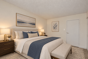 Alexandria apartment for rent - A bedroom with a large bed and a painting on the wall.