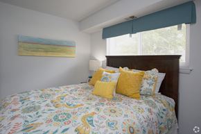 Portsmouth apartment for rent - a bedroom with a large bed with a colorful comforter and pillows