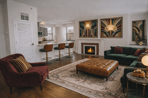 Richmond apartment for rent - A living room with a fireplace and a red chair.