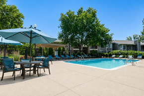 Columbia apartment for rent - A pool area with chairs and umbrellas.