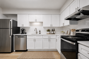 Columbia apartment for rent - A modern kitchen with white cabinets and stainless steel appliances.