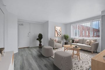 Alexandria apartment for rent - A living room with a grey couch, a wooden coffee table, and a painting on the wall.