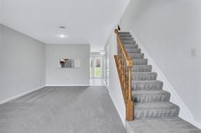 Martinsburg townhouse for rent - a gray carpeted stairway in a white house with stairs and a carpet floor
