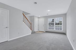 Martinsburg townhouse for rent - an empty living room with a staircase and a large window