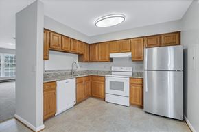 Martinsburg townhouse for rent - an empty kitchen with wooden cabinets and stainless steel appliances