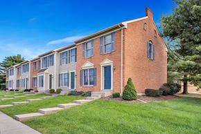 Martinsburg townhouse for rent - a brick building with blue doors and grass and trees