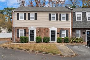 Chesapeake townhouse for rent - A two-story house with a brick facade and a black door.
