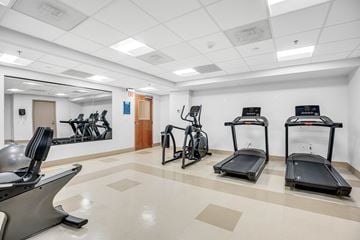 Bethesda apartment for rent - A gym with treadmills, exercise bikes, and other equipment.