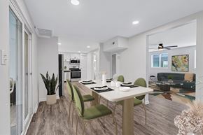 Hampton apartment for rent - A modern dining room with a white table and green chairs.