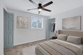 Hampton apartment for rent - A bedroom with a large bed and a ceiling fan.