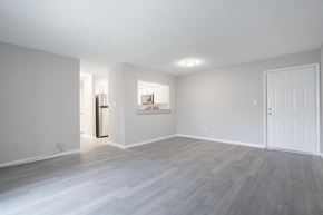 Portsmouth apartment for rent - A spacious room with a white door and a window.