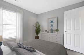 Portsmouth apartment for rent - A bedroom with a bed, nightstand, and a painting on the wall.