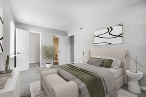Newport News apartment for rent - A bedroom with a large bed and a painting on the wall.