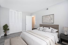 Newport News apartment for rent - A bedroom with a large bed and a painting on the wall.