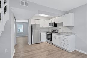 Hopewell townhouse for rent - A kitchen with white cabinets and stainless steel appliances.