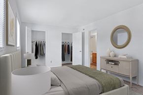 Charlottesville apartment for rent - A bedroom with a bed, a dresser, and a mirror.