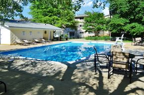 Falls Church apartment for rent - a swimming pool in a backyard with chairs and a table