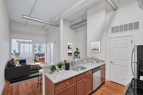 Richmond apartment for rent - an open living room with a kitchen with a counter top