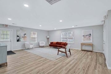 Martinsburg apartment for rent - a large living room with a couch and chairs in it