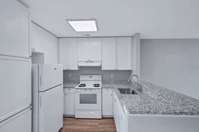 Lexington Park townhouse for rent - a kitchen with white appliances and granite counter tops