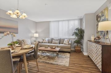 Bladensburg apartment for rent - A well-lit living room with a dining table and chairs.
