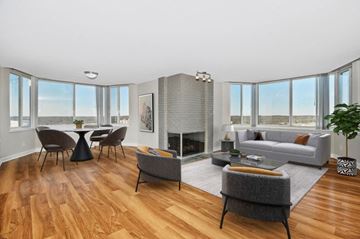 Alexandria apartment for rent - a living room with a couch and a table with chairs and a fireplace