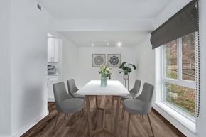 Reston apartment for rent - a dining room with a white table and chairs and a large window