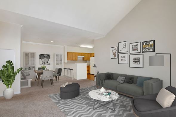 Largo apartment for rent - A living room with a grey couch, a coffee table, and a dining table with chairs.