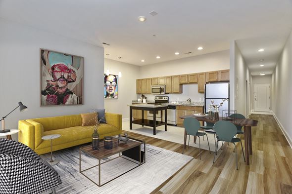 Richmond apartment for rent - a living room with a yellow couch and a dining room table
