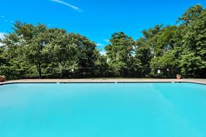 Oxon Hill apartment for rent - a swimming pool with trees in the background and a blue sky