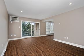 Frederick apartment for rent - a living room with a large window and wooden floors