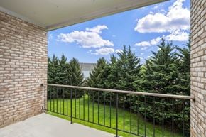 Frederick apartment for rent - a balcony with a view of a yard and trees