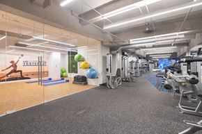 Richmond apartment for rent - a gym with exercise equipment and mirrors on the wall