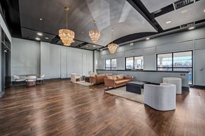 Laurel apartment for rent - A spacious room with wooden floors and modern furniture.
