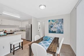 Silver Spring apartment for rent - a dining room with a table and chairs and a kitchen in the background