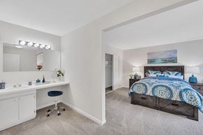 Silver Spring apartment for rent - a bedroom with a bed and a desk with a chair