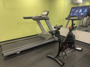 Arlington apartment for rent - A treadmill and a stationary bike are in a gym.